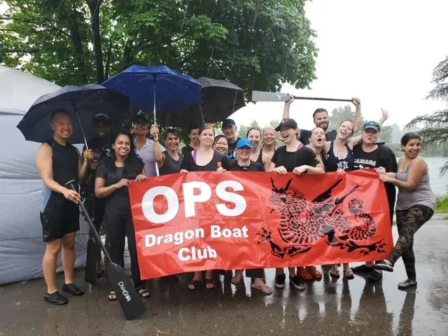 Image of the OPS Dragon Boat Team photo in a downpour.